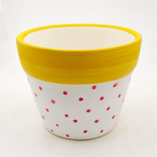 White pot with red dots